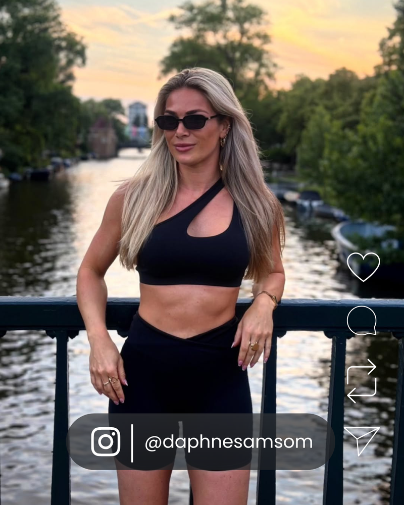 Woman wearing black VOYA sunglasses outdoors in the city.