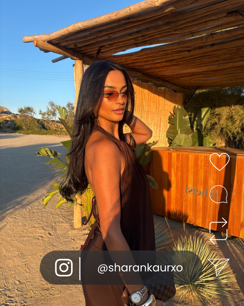 Woman styling golden VOYA sunglasses at Scorpios Mykonos